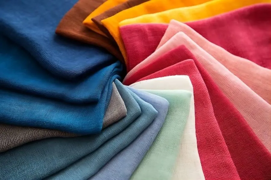 Cotton fabric rolls displayed in a textile warehouse in Pakistan representing suppliers, manufacturing, and export industry overview in 2026.
